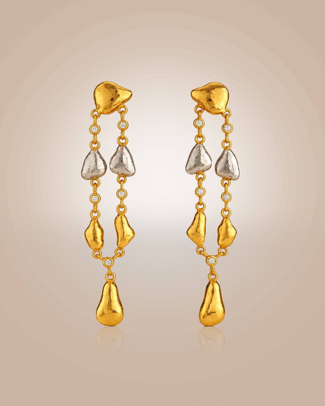 Sterling silver 22K gold vermeil & rhodium danglers; hammered oyster shell with CZ, anti-tarnish on beige background.